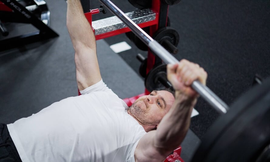 Why Do People Arch Their Back When Bench Pressing?